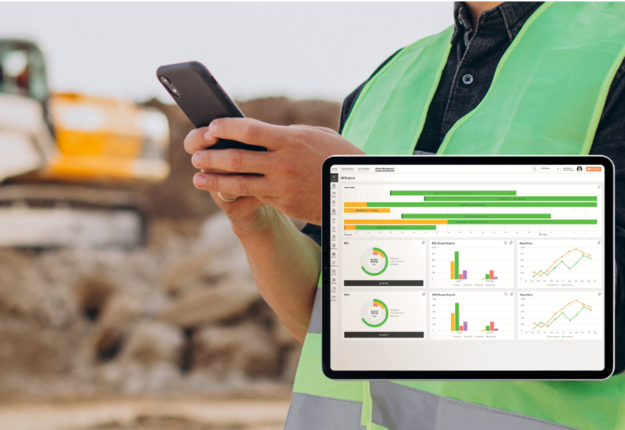 COINS construction software on a tablet with a construction site and person holding a smart phone in the background.
